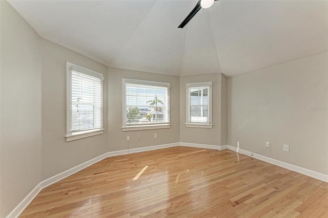 spare room with ceiling fan, light hardwood / wood-style flooring, and lofted ceiling