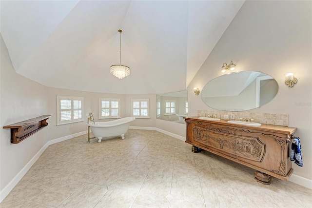 bathroom featuring vanity, tile patterned floors, vaulted ceiling, and a bath