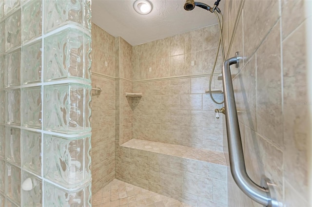 bathroom with tiled shower