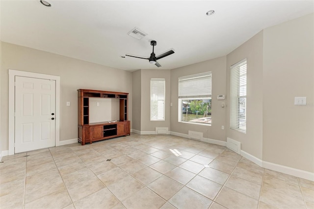 unfurnished living room with light tile patterned floors, ceiling fan, visible vents, and baseboards