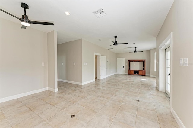 unfurnished living room featuring visible vents, ceiling fan, baseboards, and light tile patterned floors