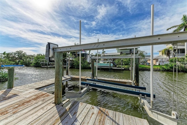 view of dock with a water view and boat lift