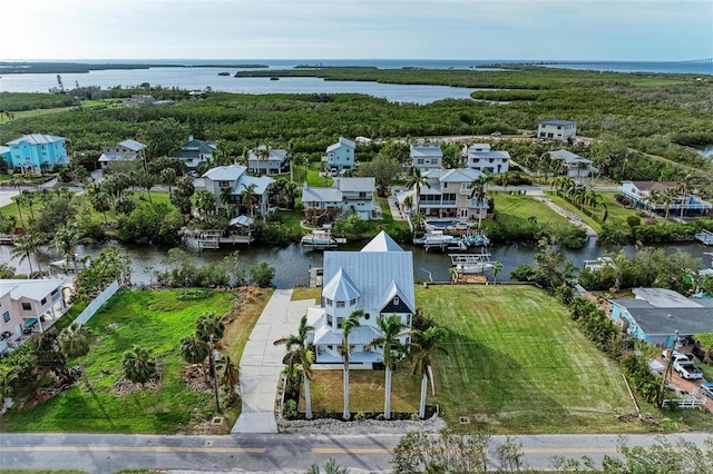 birds eye view of property featuring a water view and a residential view