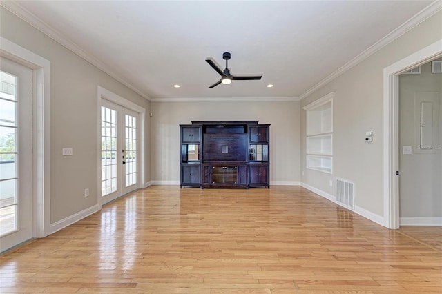 unfurnished living room with visible vents, crown molding, french doors, light wood-type flooring, and built in shelves