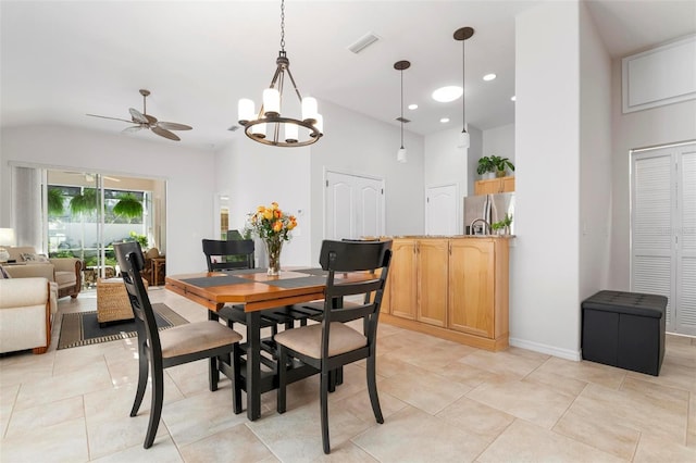 dining space with ceiling fan with notable chandelier