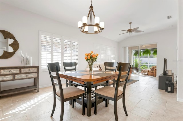 dining space featuring lofted ceiling and ceiling fan with notable chandelier