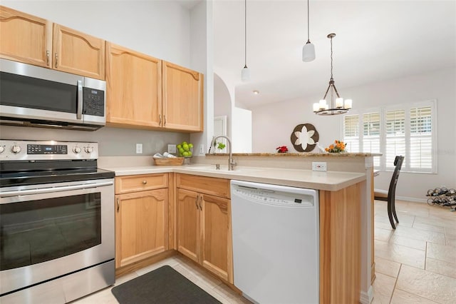 kitchen with stainless steel appliances, light brown cabinets, kitchen peninsula, a chandelier, and pendant lighting