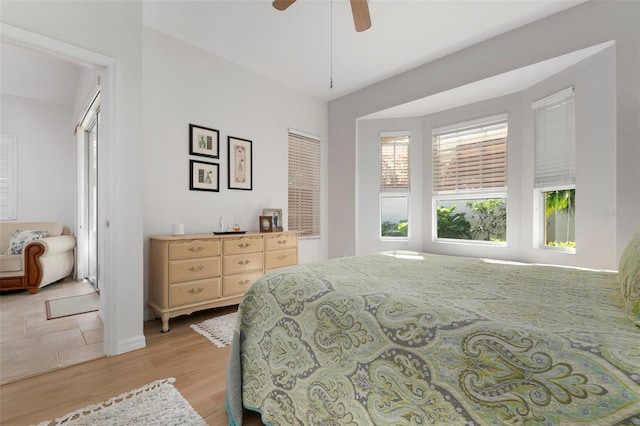 bedroom with a closet, ceiling fan, and light hardwood / wood-style floors