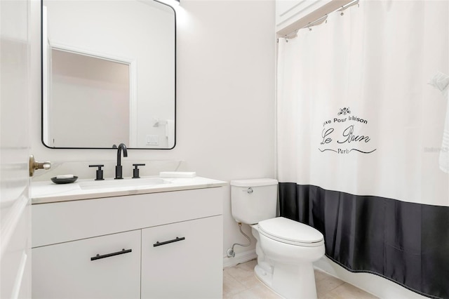 bathroom featuring vanity, tile patterned floors, and toilet