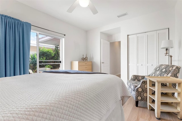 bedroom featuring wood-type flooring, a closet, and ceiling fan