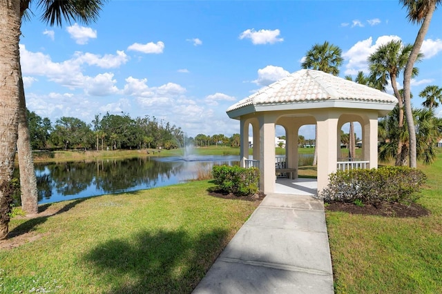 view of community with a gazebo, a lawn, and a water view