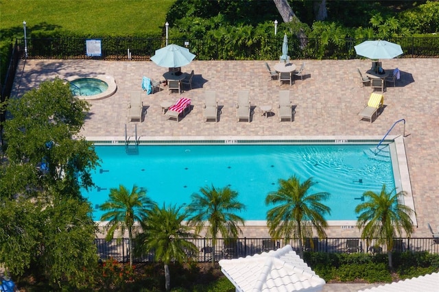 view of swimming pool featuring a community hot tub and a patio