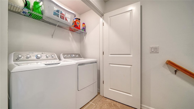 clothes washing area with separate washer and dryer and light tile patterned floors