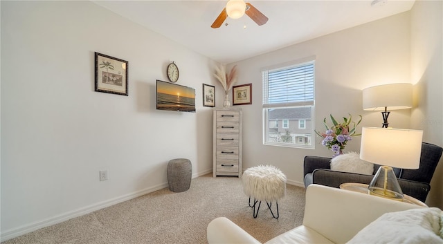 sitting room featuring ceiling fan and light colored carpet