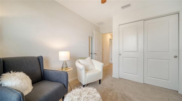 sitting room featuring light colored carpet