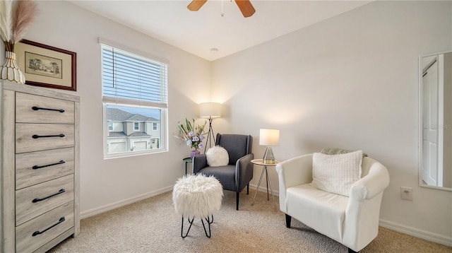 sitting room featuring ceiling fan and light carpet