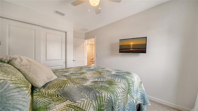 carpeted bedroom with ceiling fan and a closet