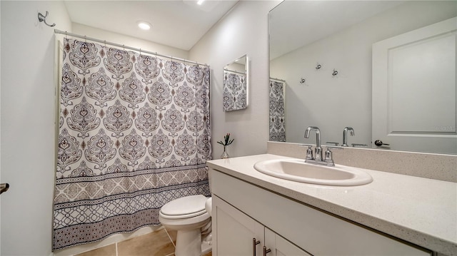 bathroom featuring toilet, tile patterned flooring, and vanity