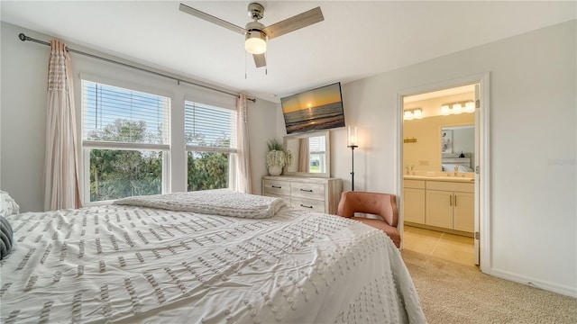 carpeted bedroom with ceiling fan and connected bathroom