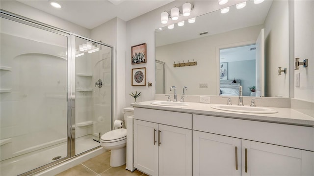 bathroom with toilet, tile patterned flooring, walk in shower, and vanity