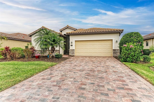 mediterranean / spanish house featuring a garage and a front yard