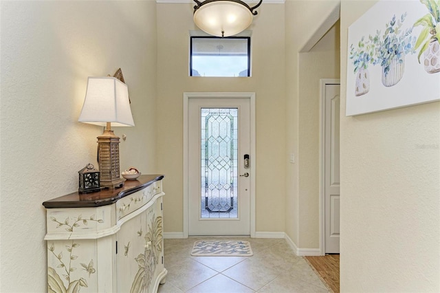 tiled entrance foyer featuring a healthy amount of sunlight