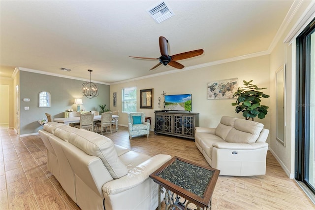 living room featuring ceiling fan with notable chandelier, ornamental molding, and light hardwood / wood-style floors