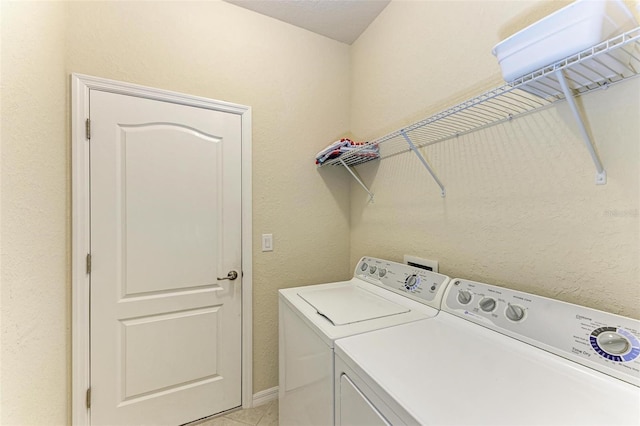 laundry room with light tile patterned floors and independent washer and dryer