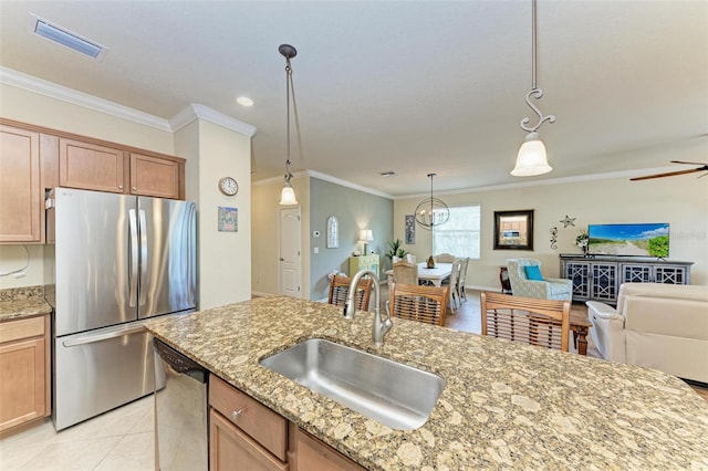 kitchen featuring crown molding, appliances with stainless steel finishes, decorative light fixtures, and sink