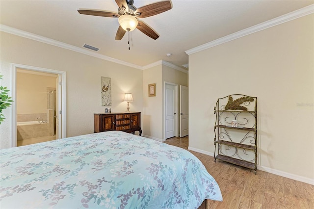 bedroom with connected bathroom, light hardwood / wood-style flooring, ornamental molding, and ceiling fan