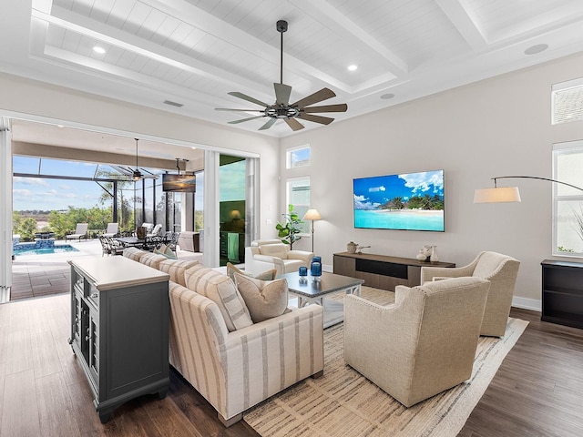 living room featuring plenty of natural light, hardwood / wood-style floors, and beamed ceiling