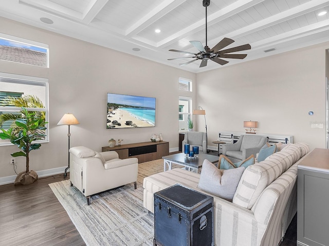 living room with ceiling fan, beam ceiling, and hardwood / wood-style flooring