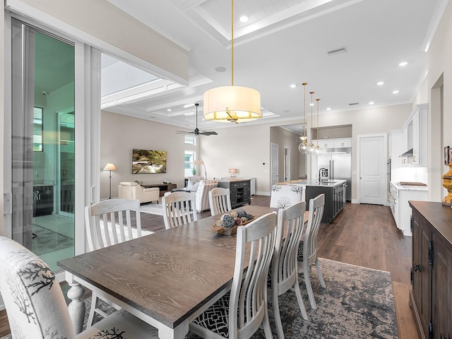 dining space with ceiling fan, dark hardwood / wood-style floors, beam ceiling, sink, and crown molding