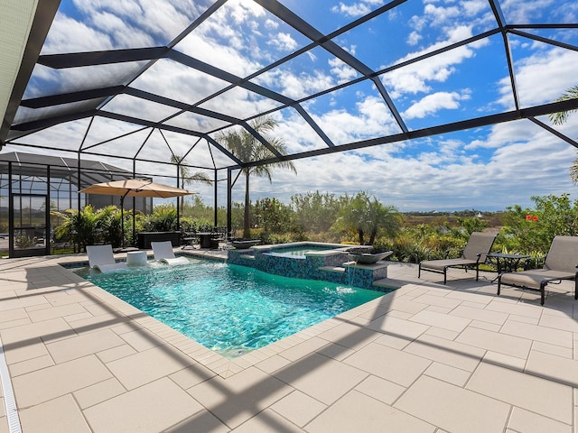 view of pool featuring pool water feature, a patio, glass enclosure, and an in ground hot tub