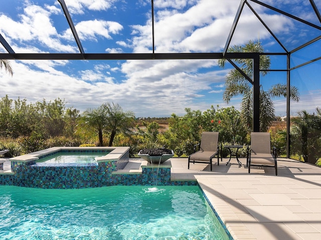 view of swimming pool with an in ground hot tub, a lanai, pool water feature, and a patio