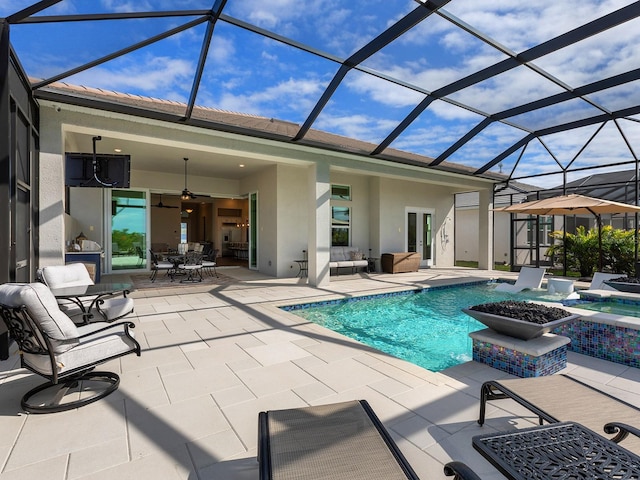 view of swimming pool with a lanai, ceiling fan, and a patio