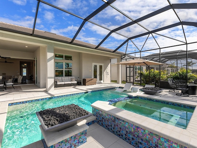 view of pool with an in ground hot tub, a lanai, an outdoor living space, and a patio area