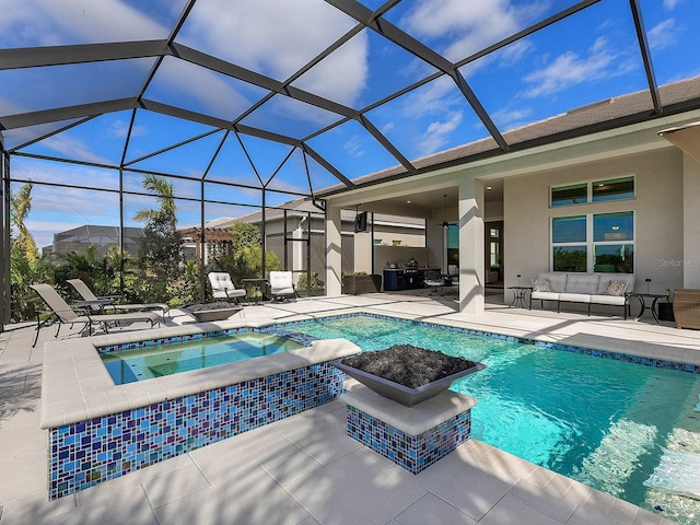 view of swimming pool featuring an in ground hot tub, a lanai, outdoor lounge area, and a patio