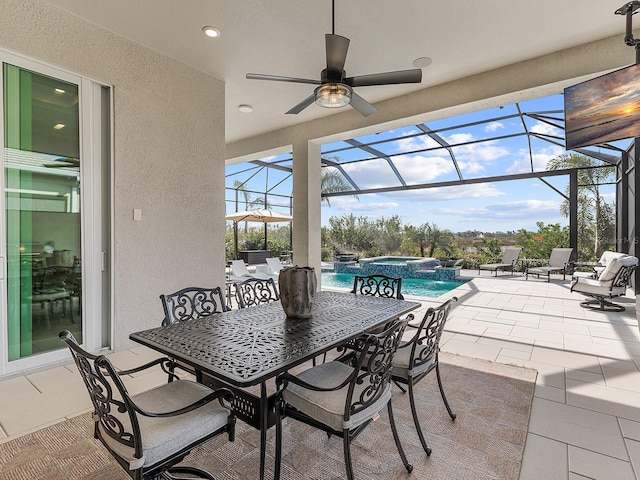 view of patio / terrace featuring a swimming pool with hot tub and glass enclosure