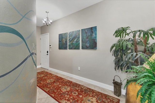 entryway with a chandelier and tile patterned floors