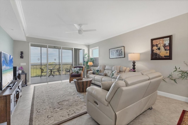 tiled living room featuring ceiling fan and crown molding