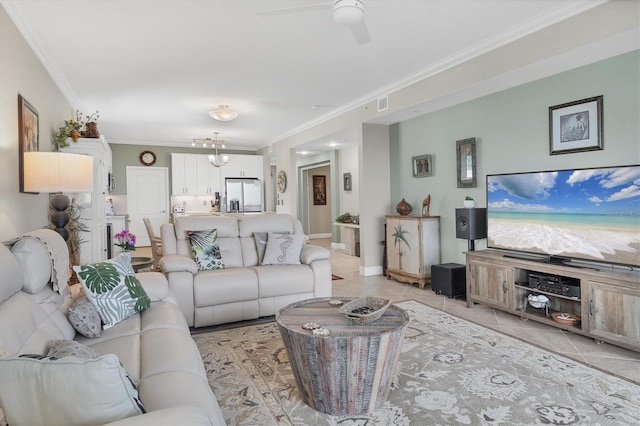 tiled living room featuring ceiling fan with notable chandelier and crown molding