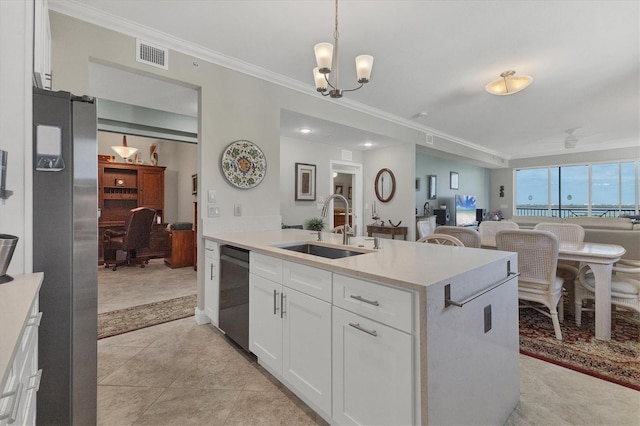 kitchen with sink, pendant lighting, white cabinets, and black dishwasher