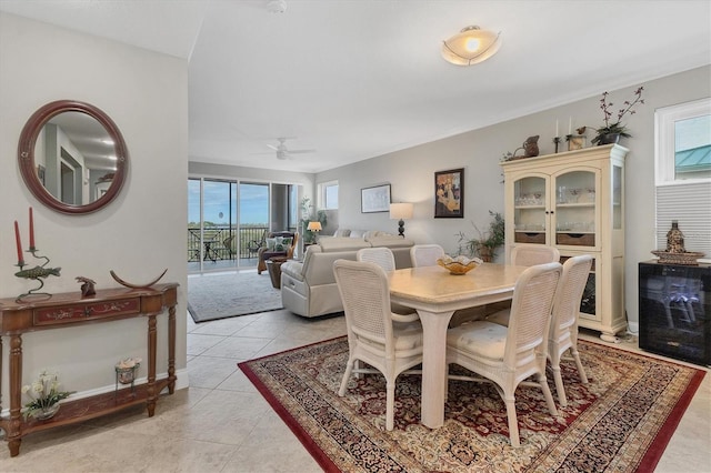 tiled dining area featuring ceiling fan