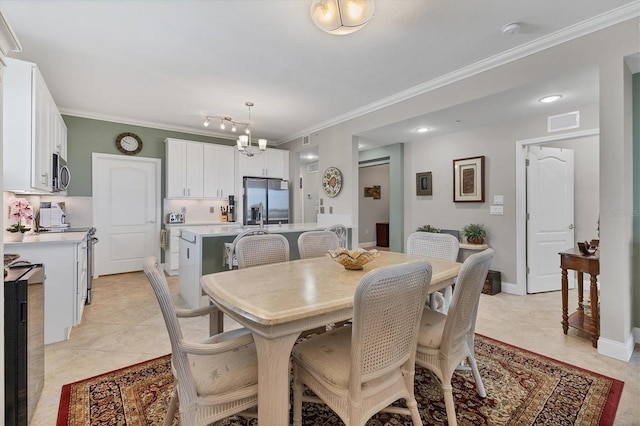 tiled dining space with a chandelier and crown molding