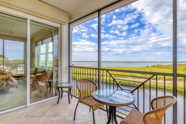 sunroom / solarium featuring a water view