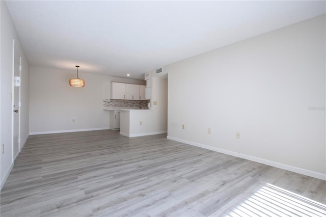 unfurnished living room with light wood-type flooring