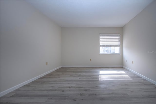 empty room with light hardwood / wood-style flooring