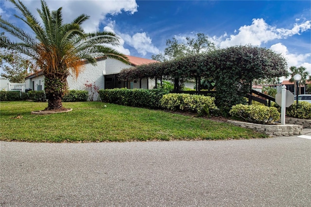 view of side of home with a yard