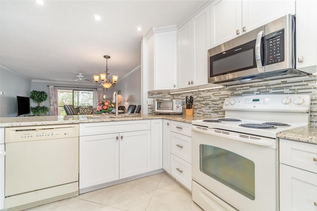 kitchen with tasteful backsplash, white cabinets, ornamental molding, light tile patterned floors, and white appliances